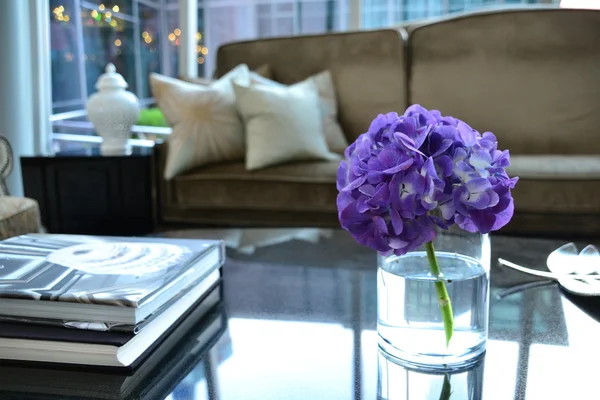 Coffee Table books, flowers and couch in hotel lobby