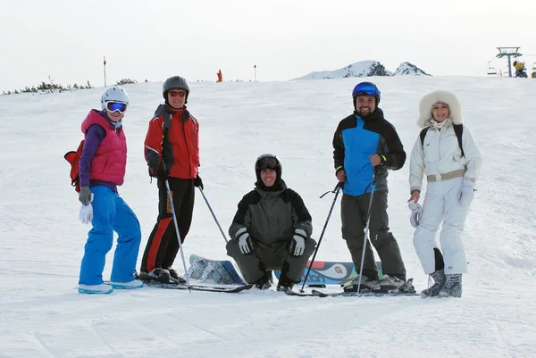 Group of young people on the mountain top Todorka Bansko ski resort in Bulgaria