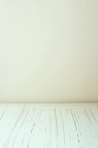 Background with white wooden table and bright wall