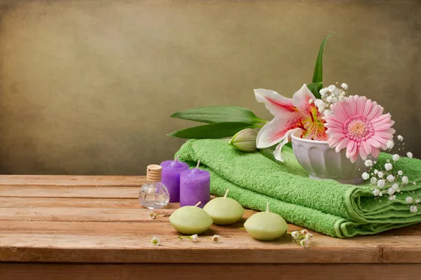 Spa concept still life with candles, towels and flowers