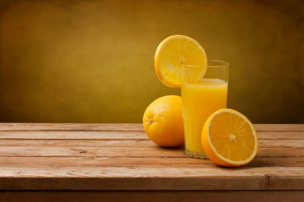 Fresh orange juice on wooden table