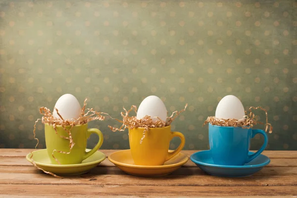 Easter decor composition with coffee cups and eggs.