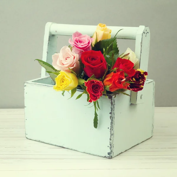 Rose flowers in wooden box