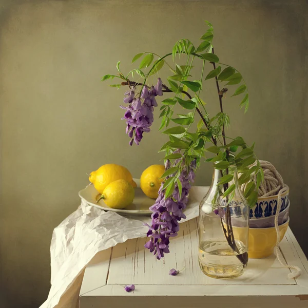 Still life with spring flowers and lemons