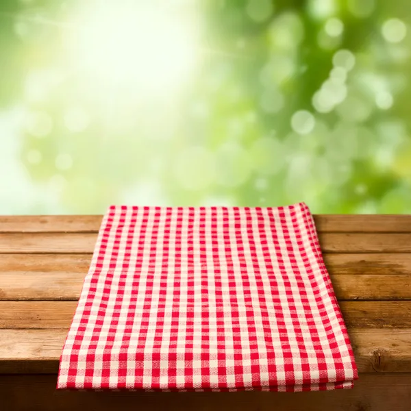 Empty wooden table with tablecloth