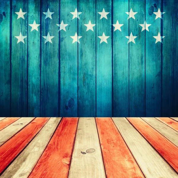 Empty wooden deck table over USA flag background.