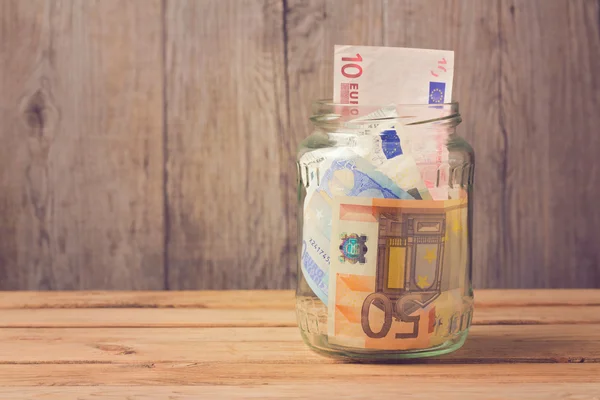 Money in glass jar