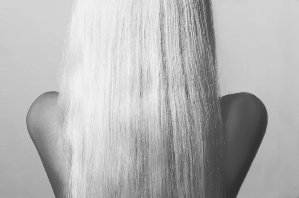 Blond Hair. Back side of Young Woman with Straight Hair. Abstract Monochrome shot