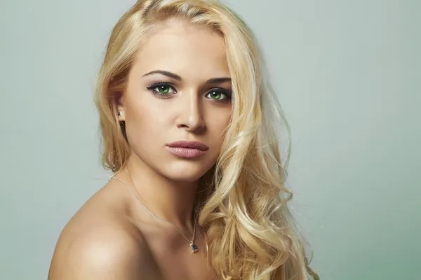 Young woman.beautiful blond girl with green eyes. Curly hair.toned