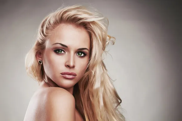 Fashion portrait of young beautiful woman.Sexy Blond girl. Gray Background.Your text here