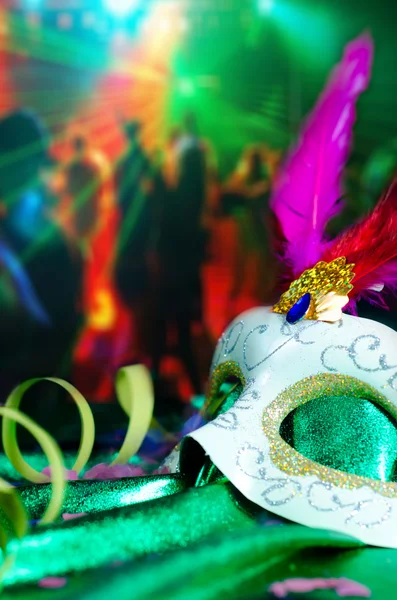 Carnival mask with party on the background.