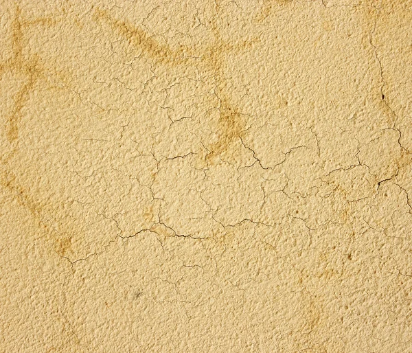 Yellow wall with cracks. Texture yellow cement wall with cracks