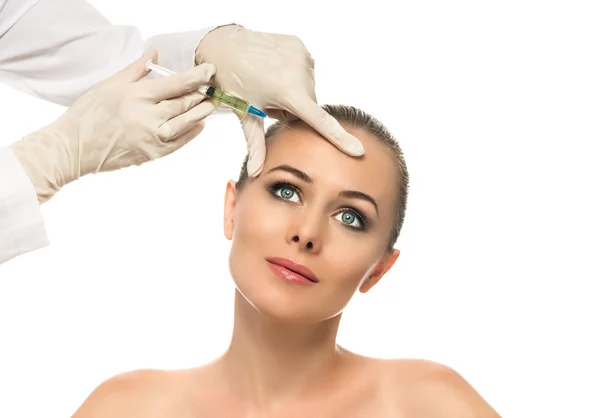 Cosmetic injection to the pretty Beautiful woman face and beautician hands with syringe. Doctor woman giving botox injections.