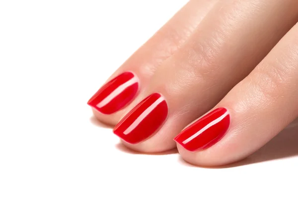 Woman hands with manicured red nails closeup. Skin and nail care.