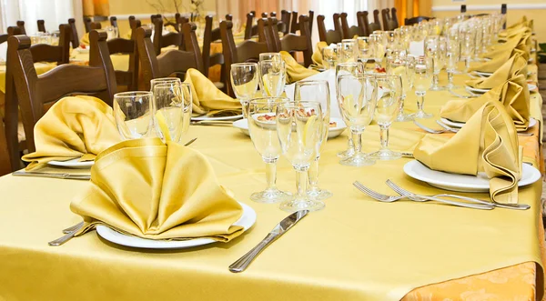 Rustic restaurant table with yellow tablecloth