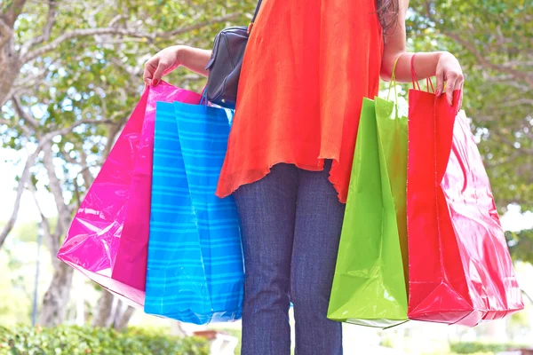Young Woman With Multi Colored Shopping Bags