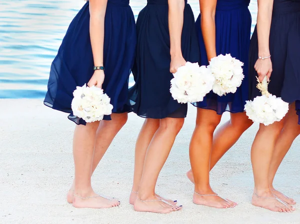 Bridesmaids with bouquets at the beach