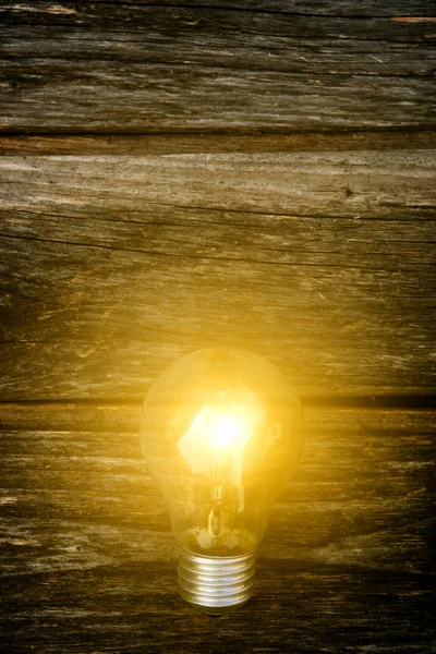 Light bulb on wood background