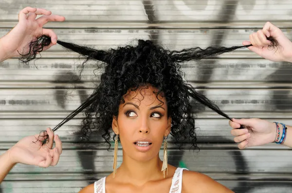 Young black woman, afro hairstyle, in urban background