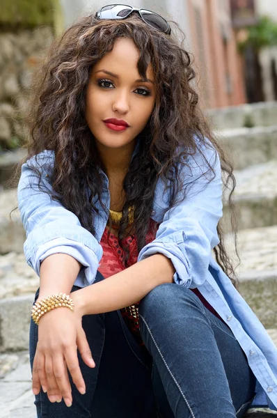 Attractive mixed woman in urban background wearing casual clothe