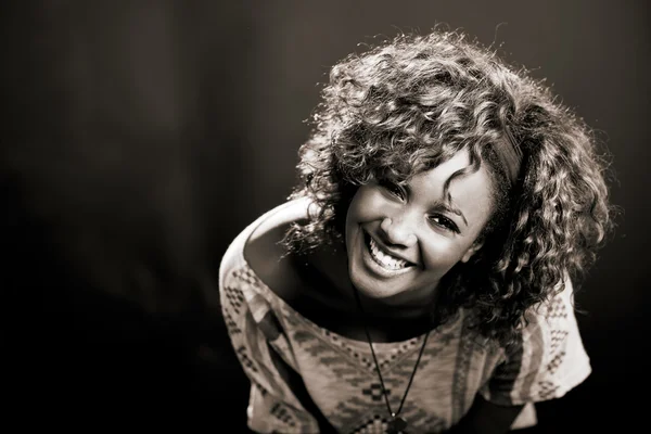 Beautiful black woman on black background. Studio shot