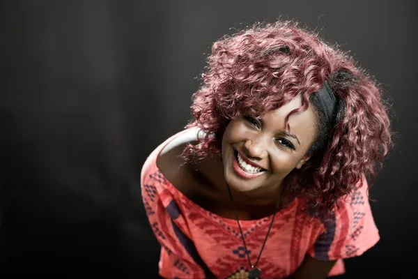 Beautiful black woman on black background. Studio shot