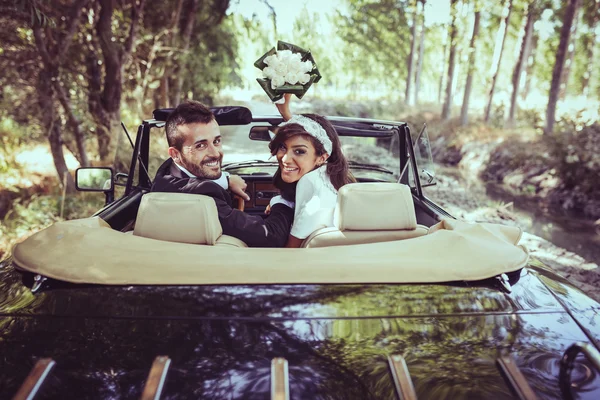 Just married couple in an old car