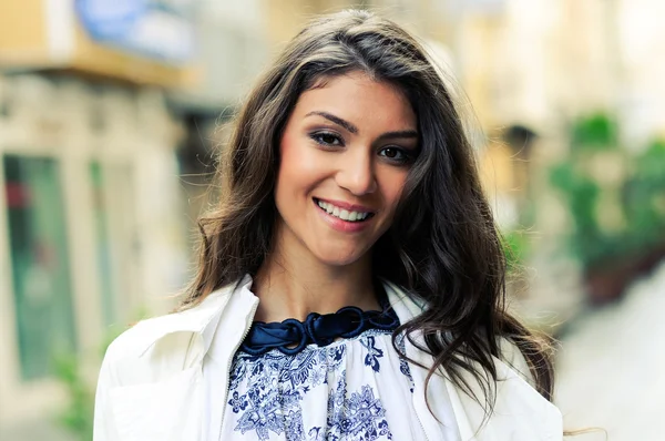 Beautiful woman smiling in urban background