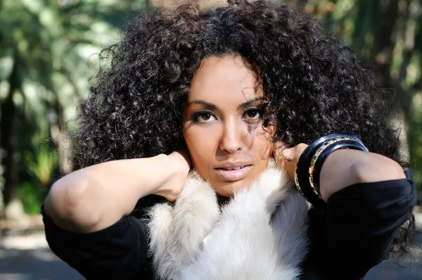 Young black woman, afro hairstyle, in urban background