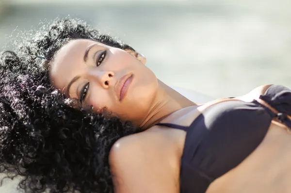 Young black woman, afro hairstyle, wearing bikini