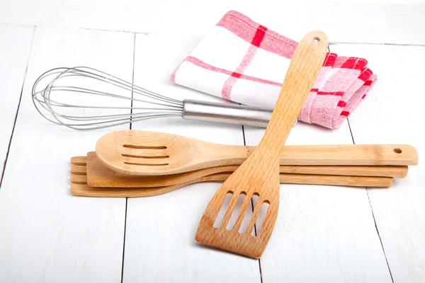 Wooden kitchen set with tea towel, on wooden white background.