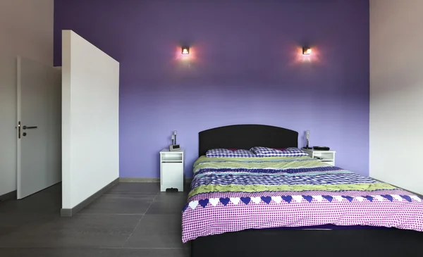 Bedroom with purple wall