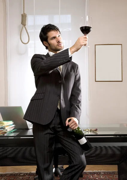 Businessman with wine and gallows