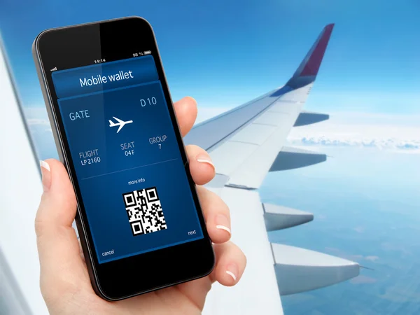 Woman hand holding the phone with mobile wallet and plane ticket