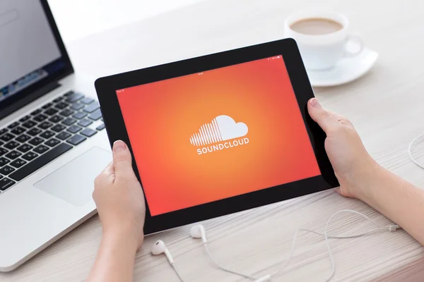IPad with app SoundCloud on the screen in female hands over the