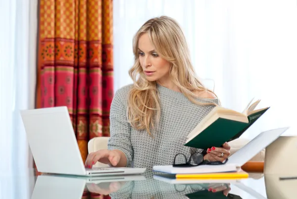 Attractive woman writing on laptop