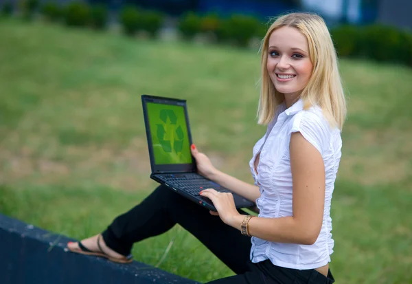 Woman with recycle logo on laptop