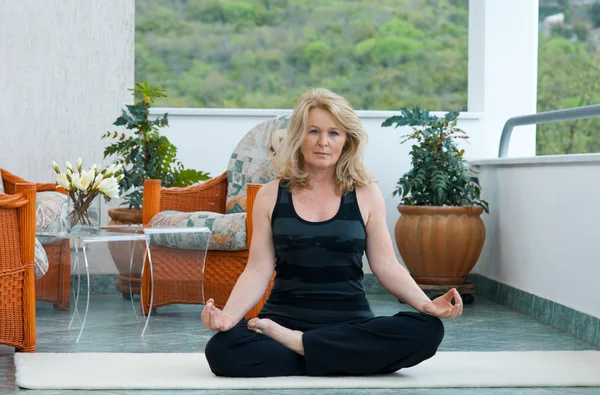 Mature woman in yoga position