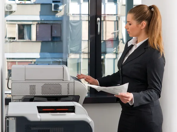 Business woman working on printer