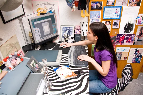 Teen girl in messy room on computer