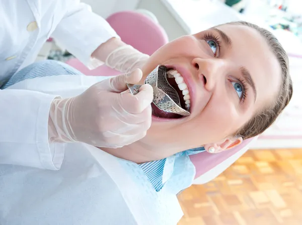 Woman with dental impression tray