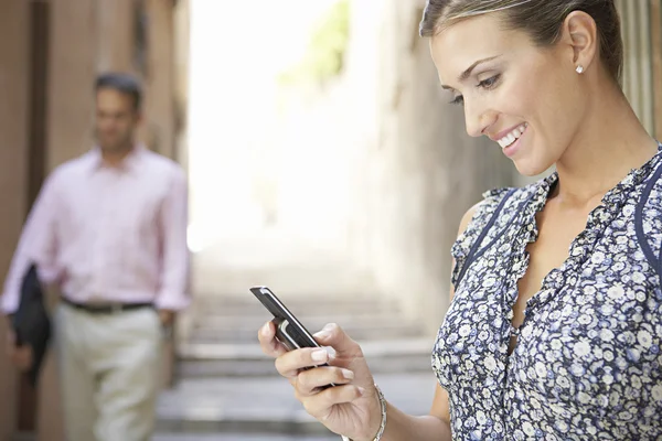 Attractive businesswoman using her cell phone outdoors