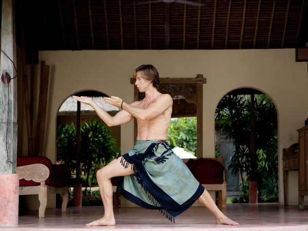 Attractive man practicing his martial arts techniques while on vacation