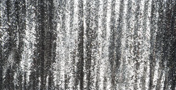 Full frame silver sequins curtain background texture.