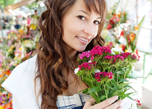 Woman smelling f flowers