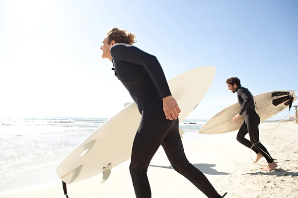 Surfers on sand beach