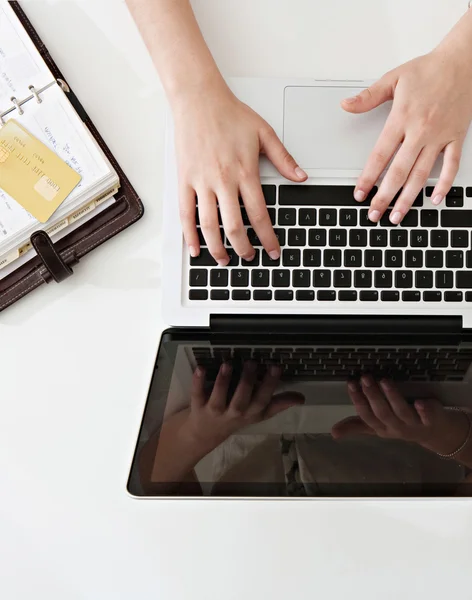 Woman hands typing  on laptop