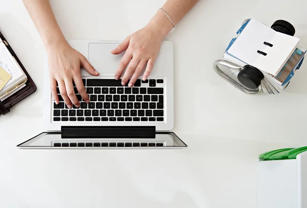 Woman hands typing on laptop