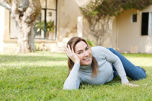 Laying down on green grass