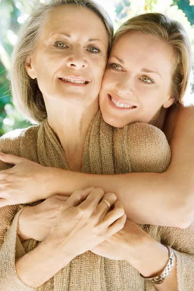 Daughter and her mature mother hugging